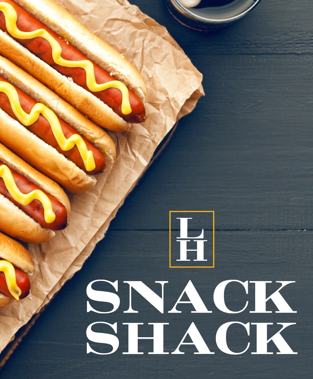 Four hot dogs in buns with mustard from the Snack Shack at the Lake House